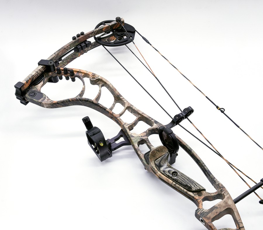 A compound bow's dual-cam and cable system Close-up of a compound bow's dual-cam and cable system in a camouflage finish