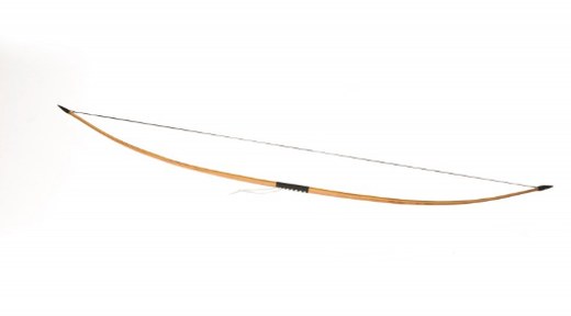 Traditional wood longbow strung and laid horizontally