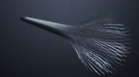A cluster of individual carbon fiber filaments splayed outward and unbound at a cut end, illustrating what a fiber tow looks like once it is separated from its resin matrix