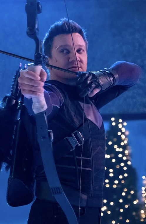 Jeremy Renner as Clint Barton / Hawkeye at full draw with a tactical recurve bow