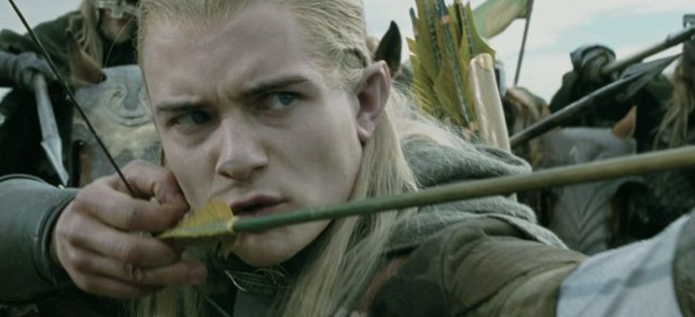 Close-up of an elven archer at anchor, arrow nocked against the cheek during a battle scene