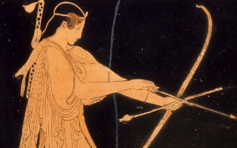 Red-figure Greek vase painting of an archer at full draw against a black background