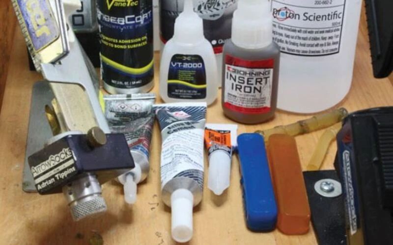 A fletching bench with insert glues, epoxy, a jig and shaft squares
