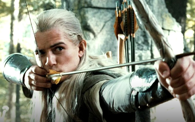 Elven archer at full draw with a recurve bow and quiver of arrows, aiming against a forest backdrop